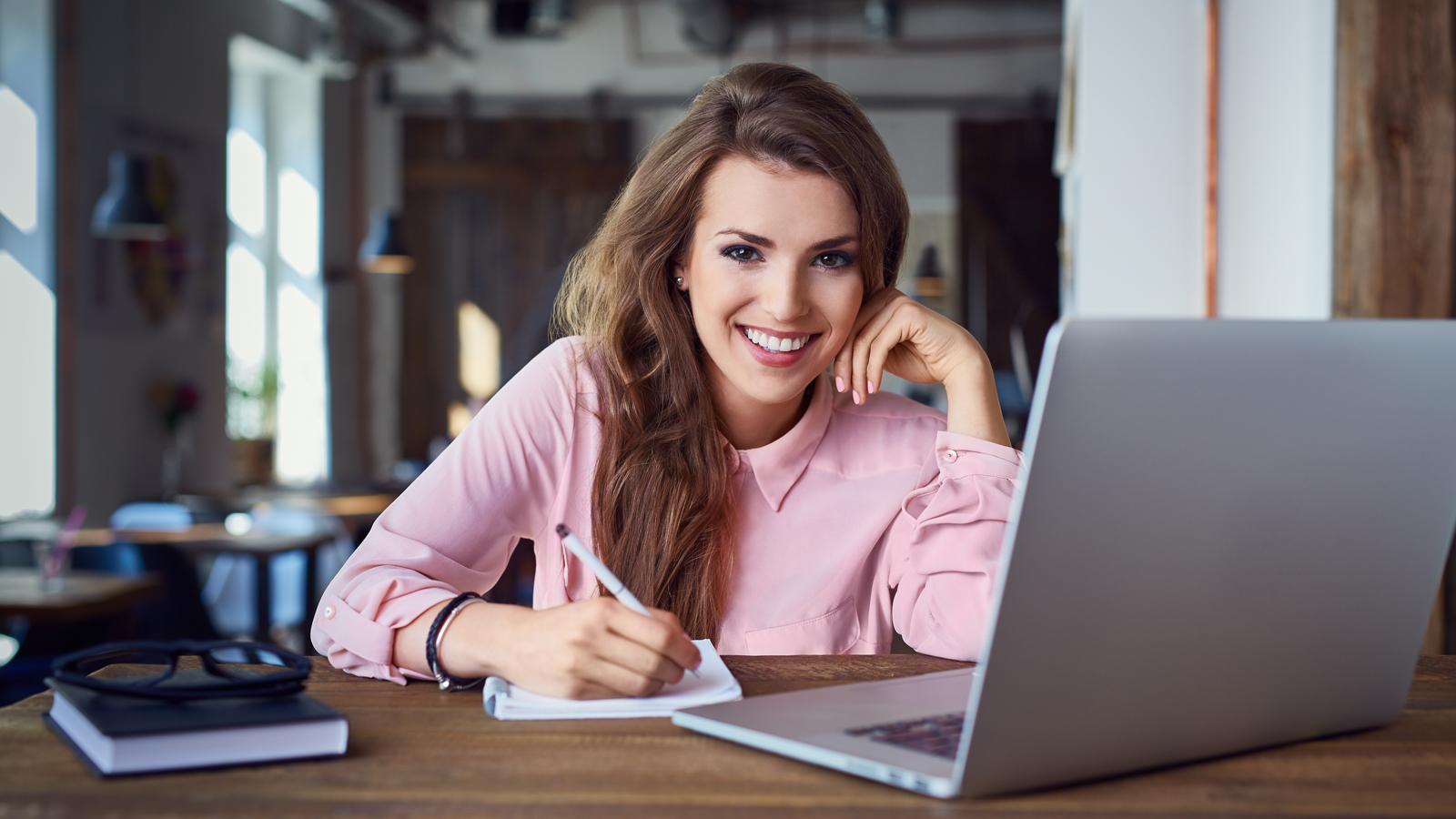 alpadia woman smiling in front of computer