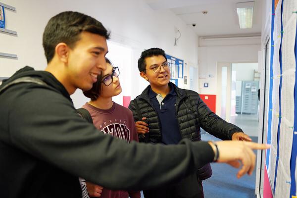 Alpadia students looking at a board in the school