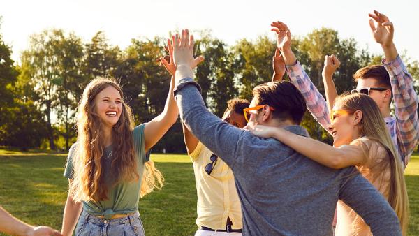 Students with arms in the air